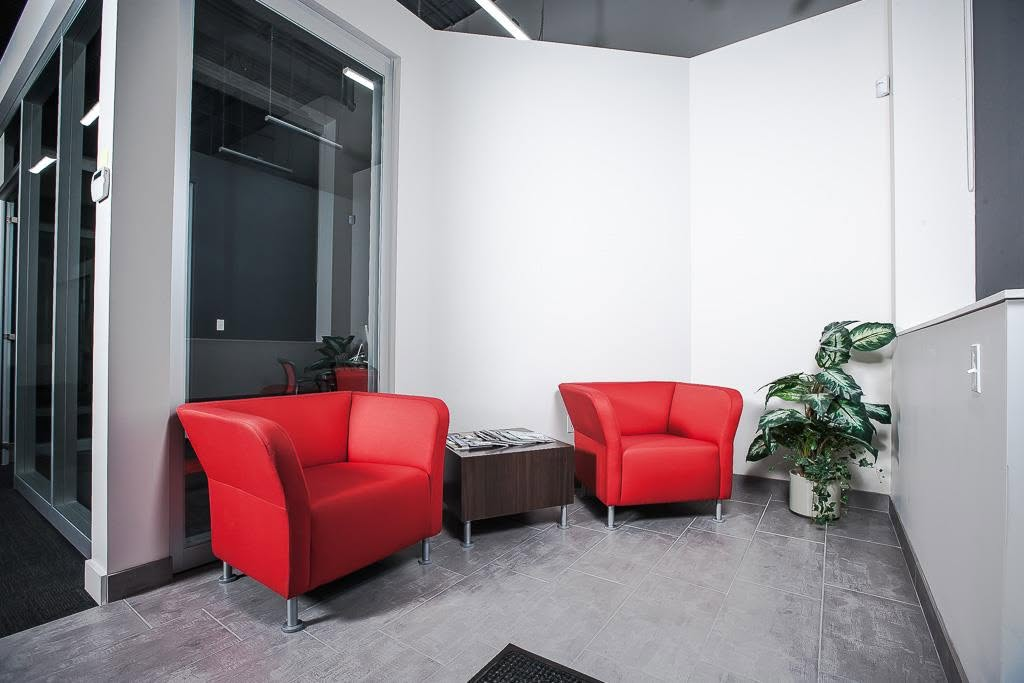 Commercial waiting area with bold red seating and minimal styling