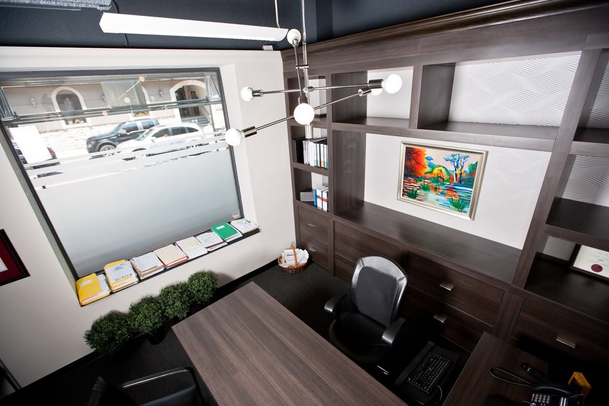 Commercial office with millwork, statement lighting, and custom shelving