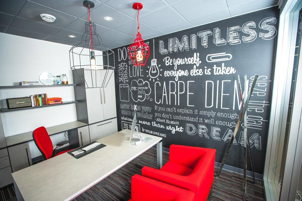 Creative office with chalkboard feature wall and sculptural lighting