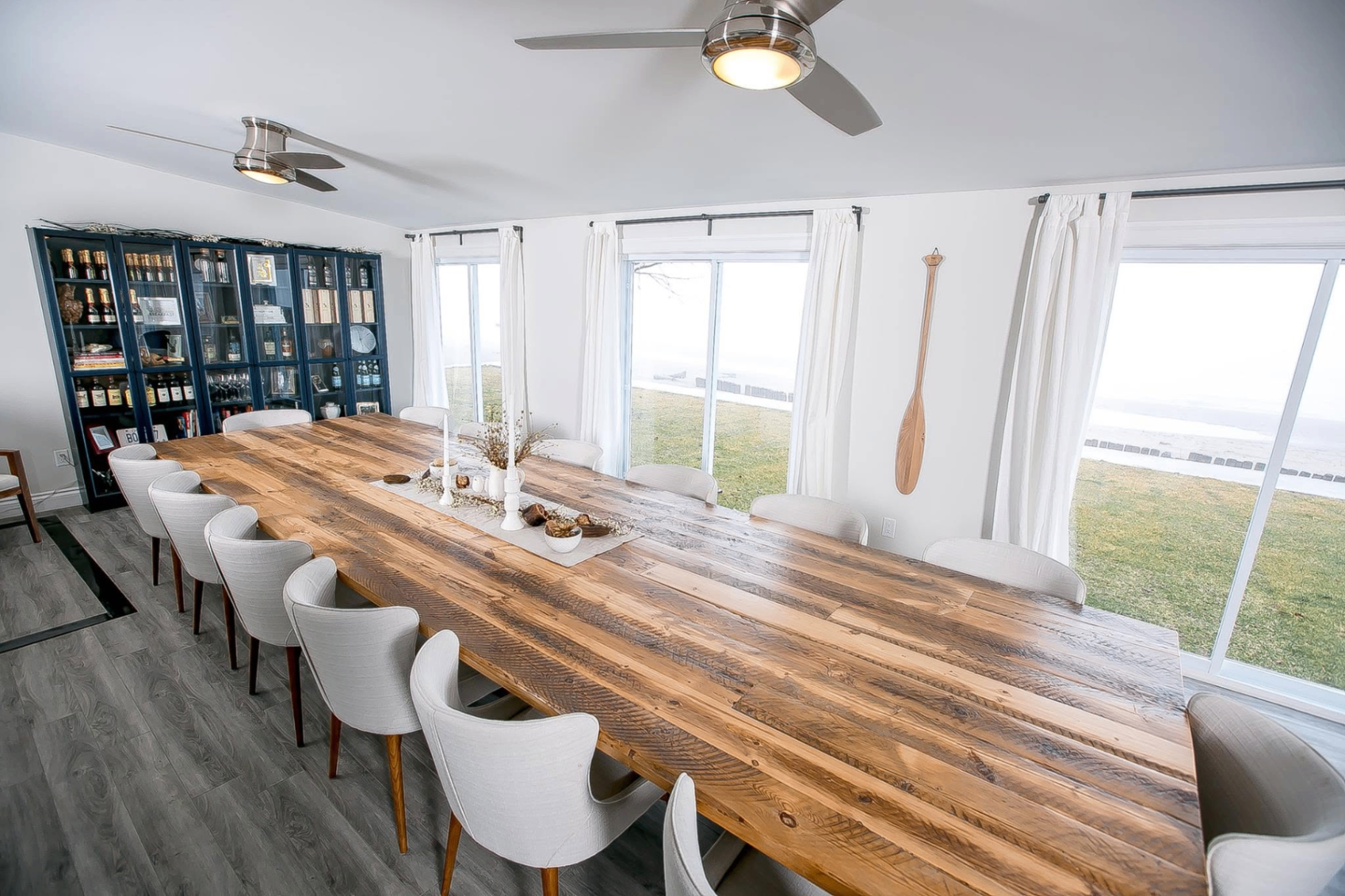 Long dining room with custom wood table and warm natural light