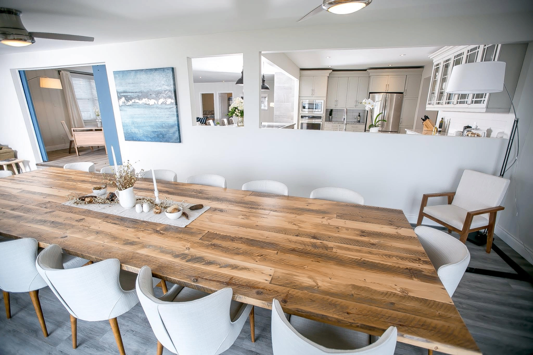 Dining room with refined neutral palette and adjoining kitchen view