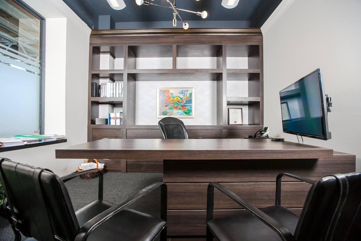 Executive office with custom walnut millwork and statement lighting